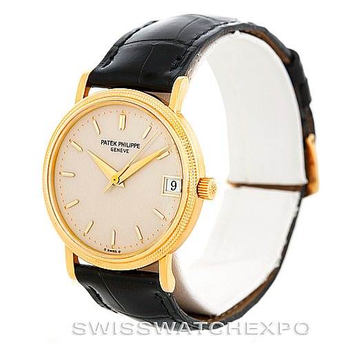 This image shows a side-front view of a vintage Patek Philippe watch, highlighting the dial, case, crown, and black leather strap.