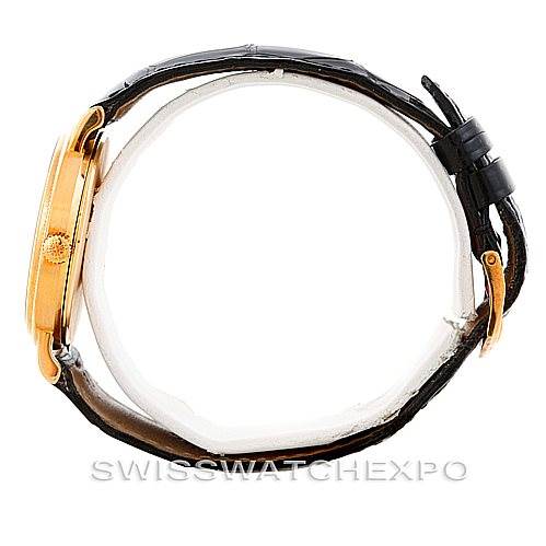 Side view of a Vintage Patek Philippe watch showing the crown, case, and leather strap.