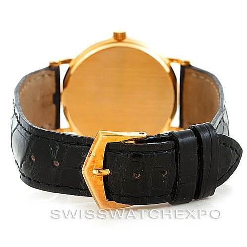 The image shows the back view of a Vintage Patek Philippe watch, highlighting the leather strap and gold clasp.