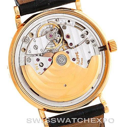 This is a rear view of a Vintage Patek Philippe watch, showcasing its interior mechanical movement and rotor.