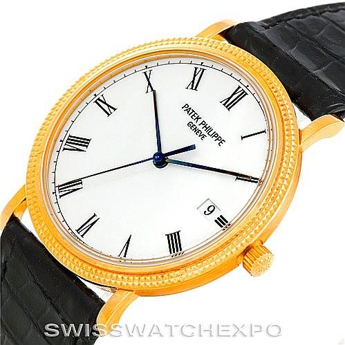 This image shows the face and part of the black leather strap of the Patek Philippe Calatrava 3944 Men's Yellow Gold White Dial 3944 Men's Yellow Gold White Dial watch at an angled view.