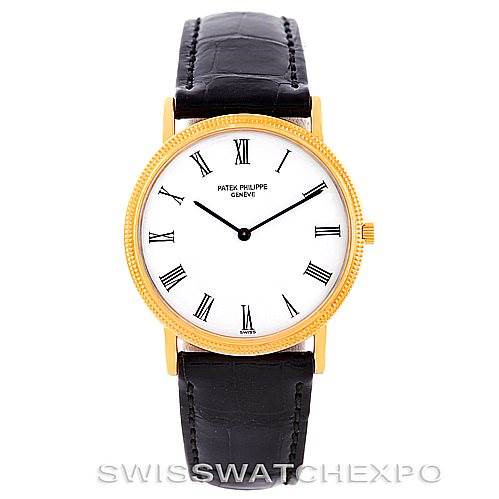 This image shows a frontal view of a Patek Philippe Calatrava watch with a gold case, white dial, Roman numerals, and black leather strap.