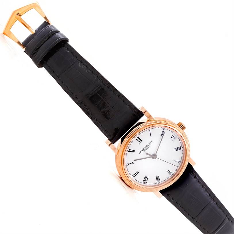 This Patek Philippe Calatrava 3802 Men's Rose Gold White Dial 3802 Men's Rose Gold White Dial watch is shown from a top-down angle, highlighting the face, strap, and buckle.