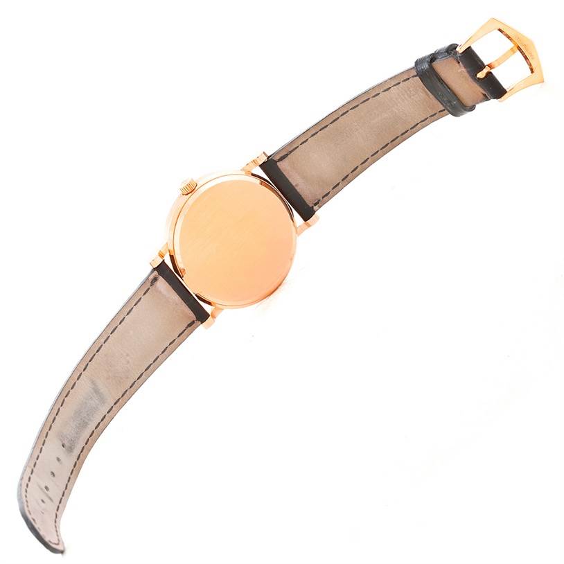 This image shows the back of the Patek Philippe Calatrava 3802 Men's Rose Gold White Dial 3802 Men's Rose Gold White Dial watch and its strap at an angled view.