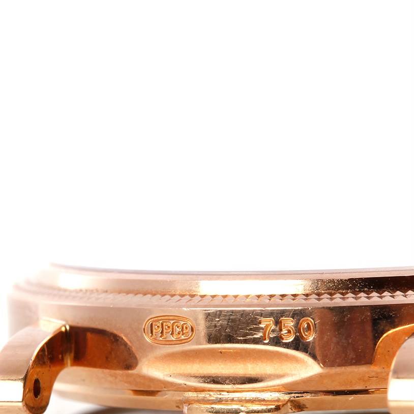 This image shows a close-up of the side of a Patek Philippe Calatrava 3802 Men's Rose Gold White Dial 3802 Men's Rose Gold White Dial watch case, highlighting the 750 gold hallmark and PPCo stamp.