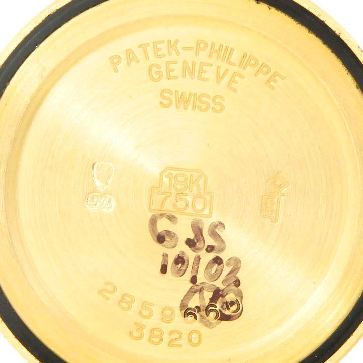 This image shows the interior case back of a Vintage Patek Philippe watch, including engravings and hallmarks.