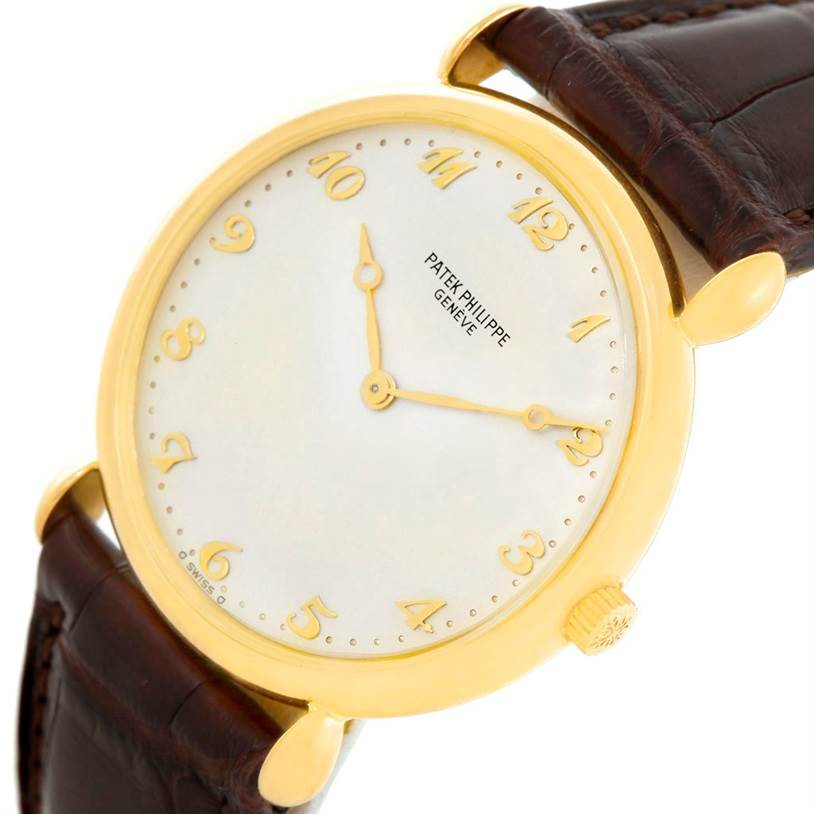 This image shows a close-up of the face and part of the brown strap of a Vintage Patek Philippe watch.