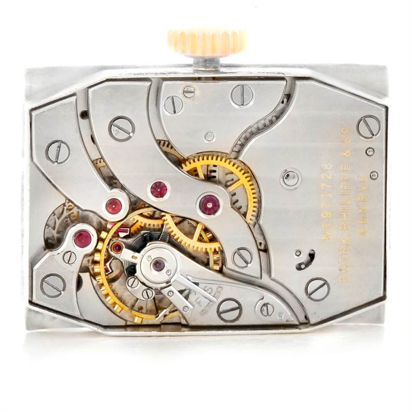 The image shows the intricate internal mechanics of a vintage Patek Philippe watch model.