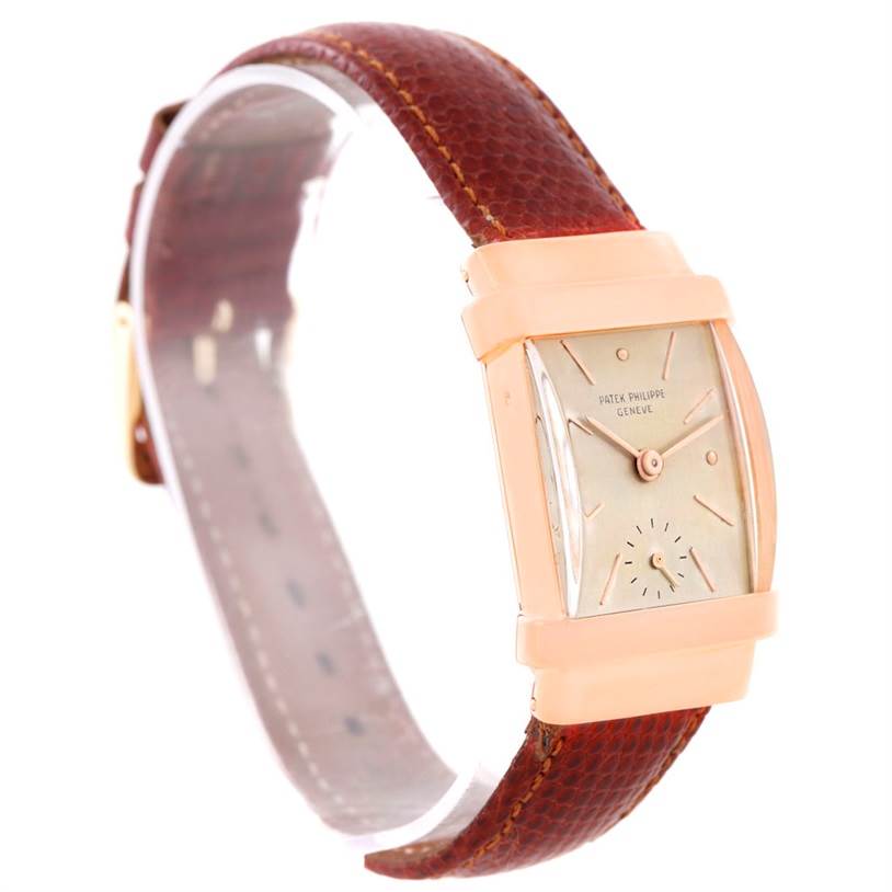 This Vintage Patek Philippe watch is shown at an angle highlighting its rectangular face, leather strap, and minimalist dial design.