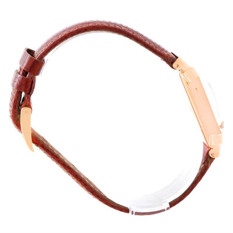 The image shows a side view of a Vintage Patek Philippe watch, highlighting its case, brown leather strap, and buckle.