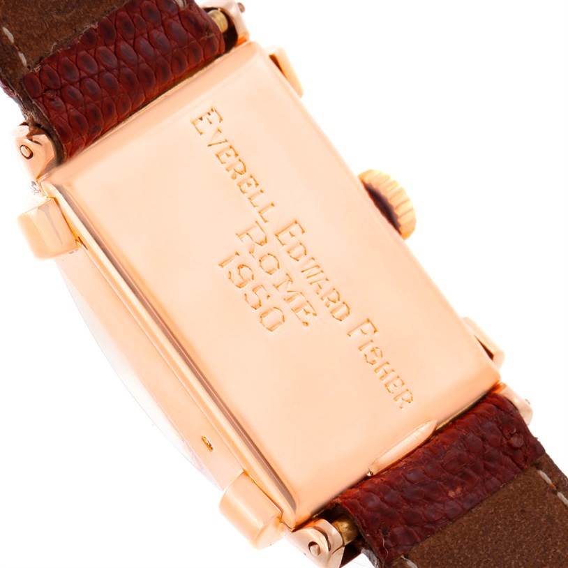 This image shows the back case and brown leather strap of a vintage Patek Philippe watch, model engraved with "Everell Edward Fisher, Rome 1950."