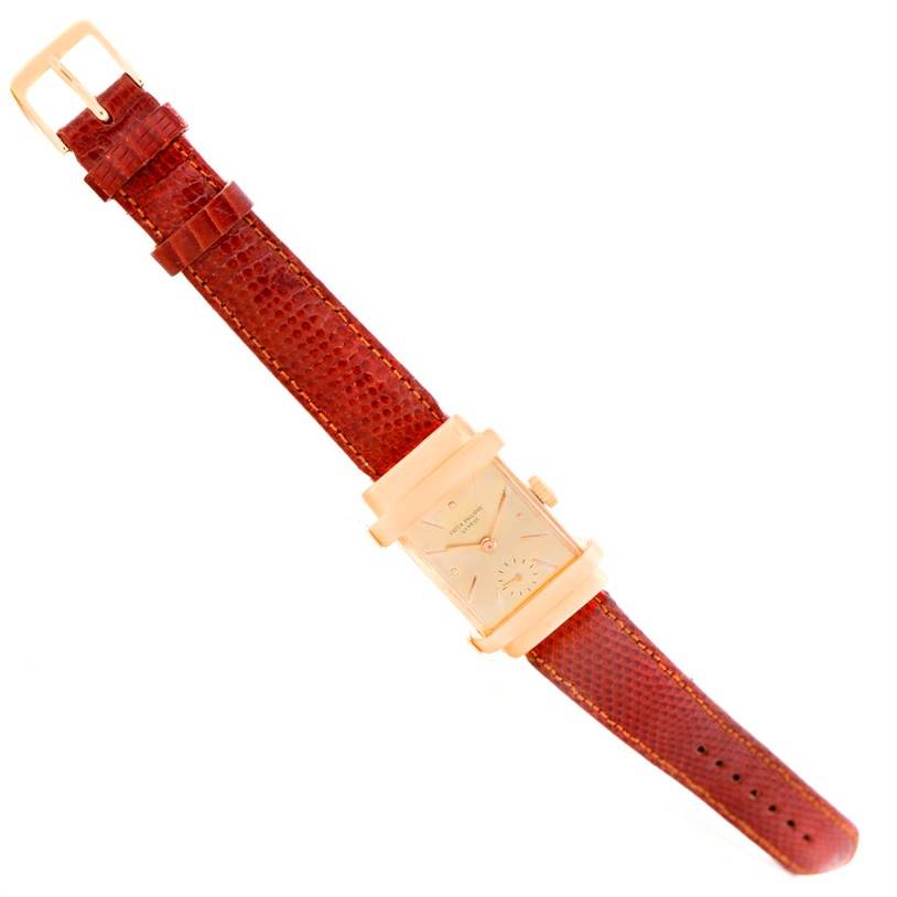 This image shows a top-down angle of a Vintage Patek Philippe watch with a rectangular dial and a brown leather strap.