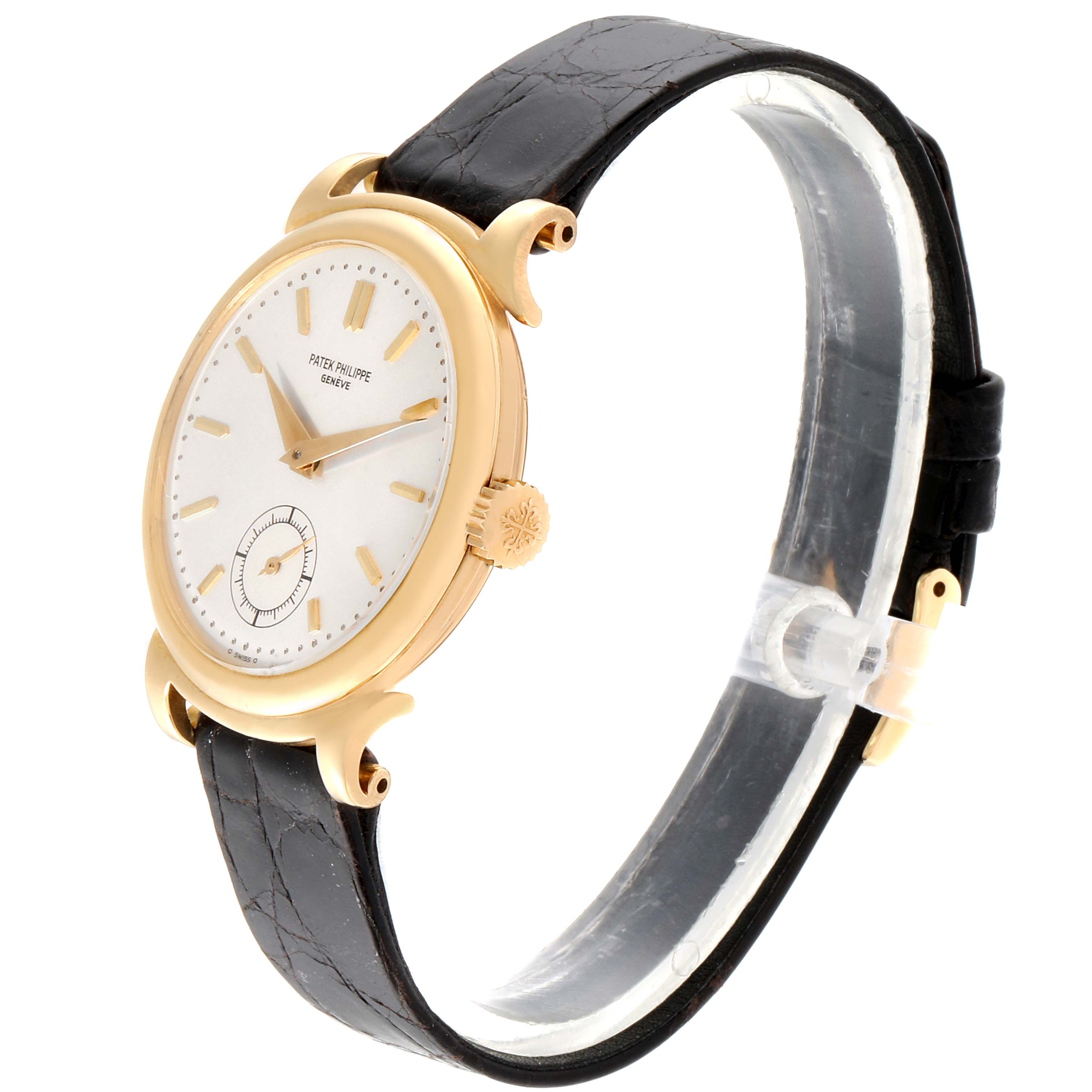 The image shows a left-side angled view of a Vintage Patek Philippe watch, highlighting its round face, gold case, and black leather strap.