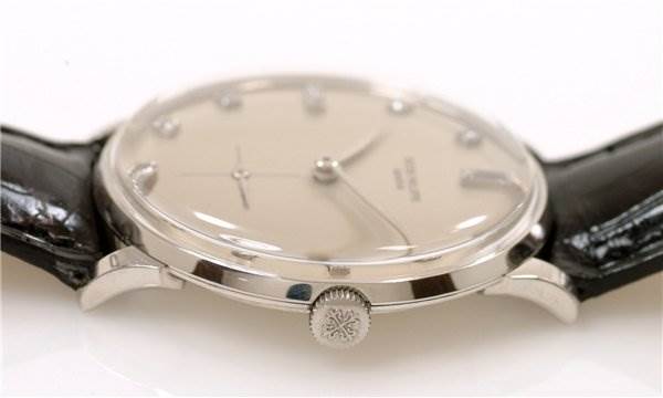 The image shows a side view of the Patek Philippe 2573/2 Platinum Silver Dial 2573/2 Platinum Silver Dial Vintage Men Platinum Diamond 2573/2 Rare model watch, focusing on the crown and lug.