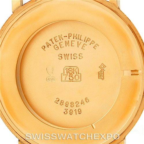 The image shows the case back of the Patek Philippe Calatrava 3919 Men's Yellow Gold White Dial 3919 Men's Yellow Gold White Dial watch, displaying its inscriptions and gold purity marks.