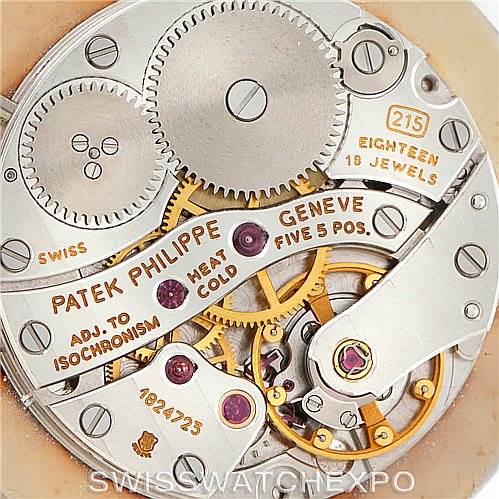 This image shows the movement and internal mechanics of the Patek Philippe Calatrava 3919 Men's Yellow Gold White Dial 3919 Men's Yellow Gold White Dial watch, highlighting gears and inscriptions.