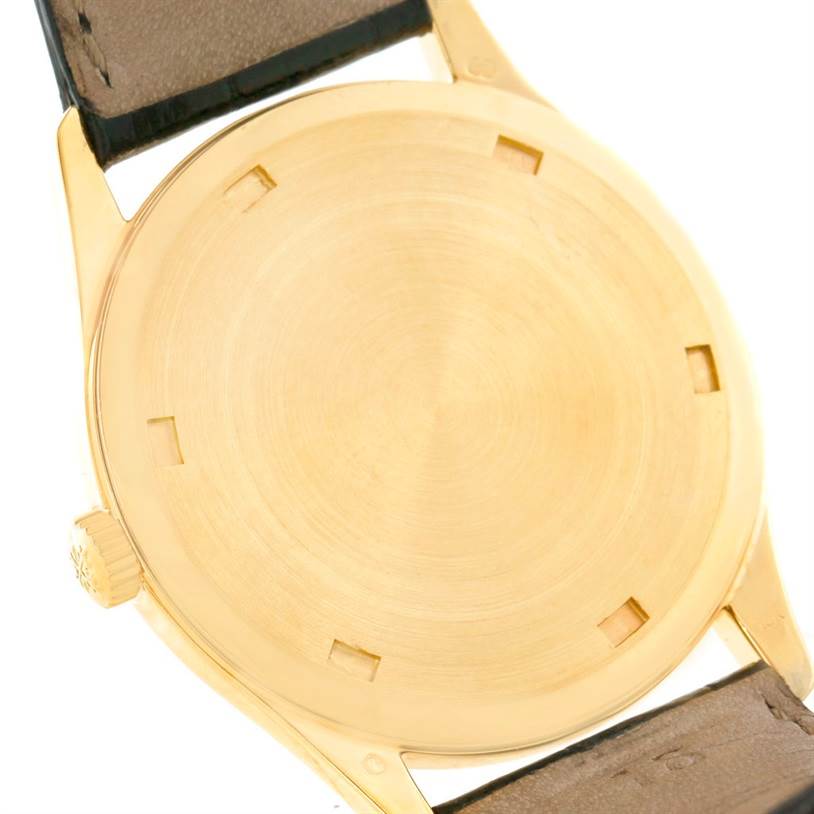 The image shows the back case of a Patek Philippe Calatrava 5023 Men's Yellow Gold Silver Dial 5023 Men's Yellow Gold Silver Dial watch, viewed at an angle highlighting the crown and leather strap.