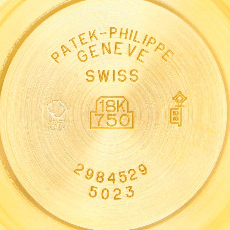 The image shows the back case of a Patek Philippe Calatrava 5023 Men's Yellow Gold Silver Dial 5023 Men's Yellow Gold Silver Dial model, indicating it's made of 18K gold.
