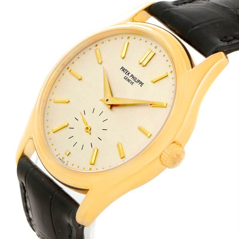 The image shows a Patek Philippe Calatrava 5023 Men's Yellow Gold Silver Dial 5023 Men's Yellow Gold Silver Dial watch at a slight angle displaying the face, crown, and leather strap.