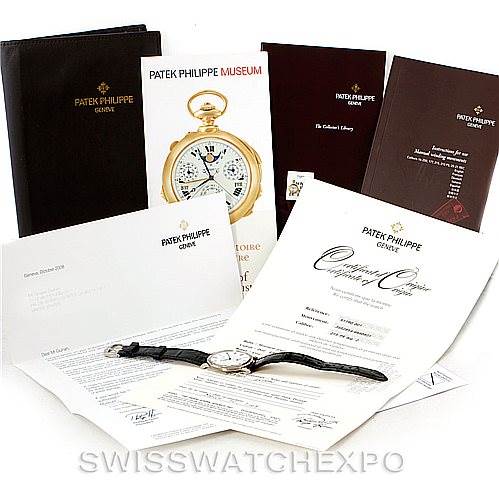 The image shows a Patek Philippe Calatrava 5119G Men's White Gold White Dial 5119G Men's White Gold White Dial watch with its instruction manuals, certificates, and brochures.