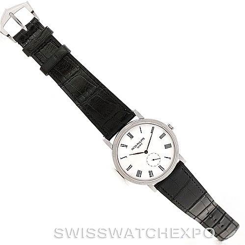 The image shows a top-down view of a Patek Philippe Calatrava 5119G Men's White Gold White Dial 5119G Men's White Gold White Dial watch, including the black leather strap and the white dial.