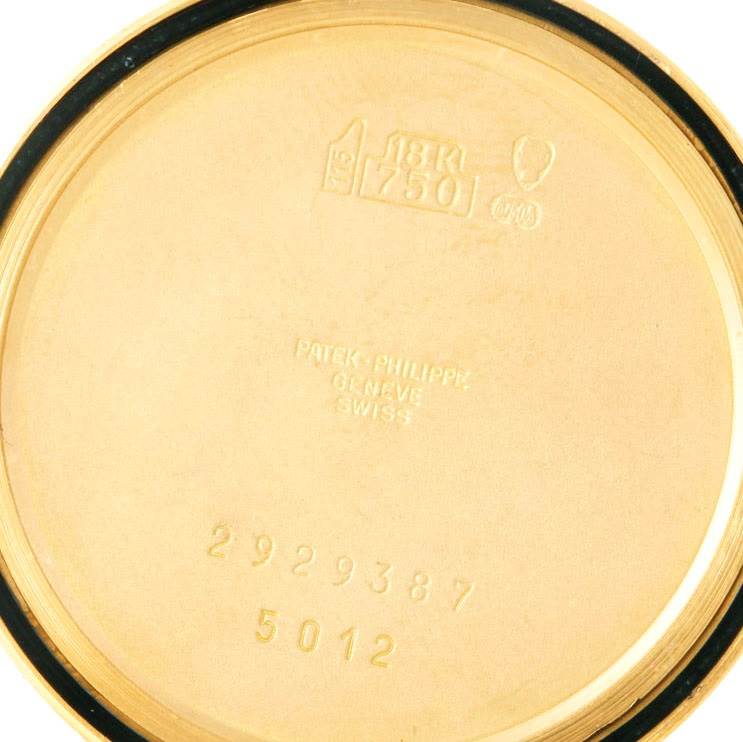 The image shows the inside of the case back of a Patek Philippe Calatrava 5012 Men
s Yellow Gold Beige Dial 5012 Men
s Yellow Gold Beige Dial model, displaying hallmarks and serial numbers.