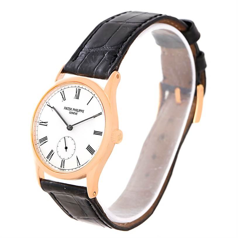 The image shows a Patek Philippe Calatrava 3796R Men
s Rose Gold White Dial 3796R Men
s Rose Gold White Dial watch at an angle highlighting its face, case, and leather strap.