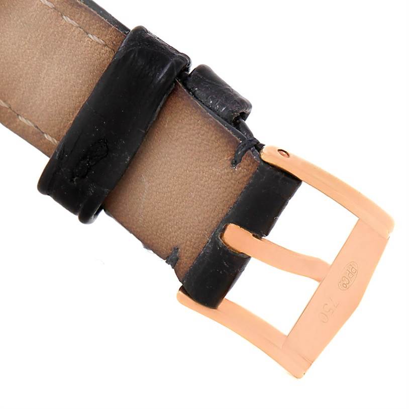 The image shows the leather strap and gold buckle of the Calatrava model by Patek Philippe from a close-up angle.