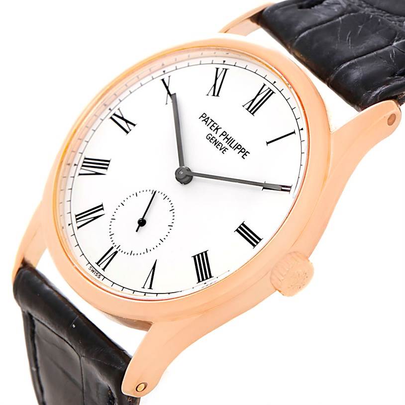 The image shows a side angle of a Patek Philippe Calatrava 3796R Men
s Rose Gold White Dial 3796R Men
s Rose Gold White Dial watch, displaying its face, crown, and part of its leather strap.