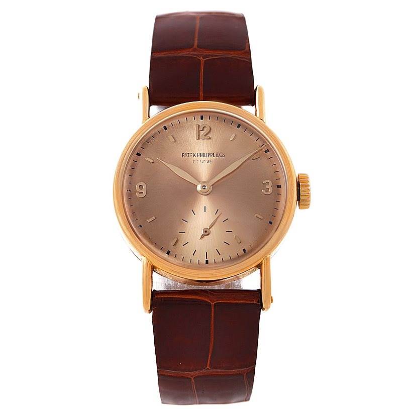 This image shows a front view of a Vintage Patek Philippe watch, highlighting its dial, hands, case, and brown leather strap.