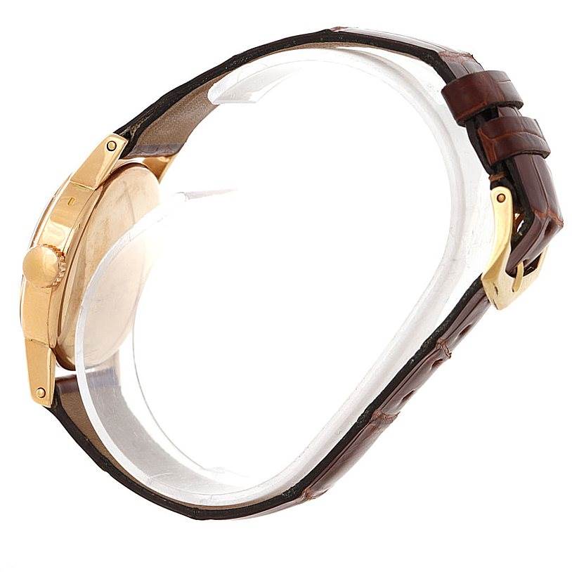 The image shows a side view of a Vintage Patek Philippe watch, highlighting its case, crown, and brown leather strap with a buckle.