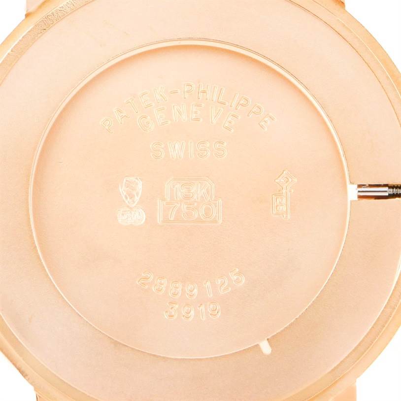 This image shows the back casing of a Patek Philippe Calatrava 3919 Men
s Rose Gold White Dial 3919 Men
s Rose Gold White Dial watch with engravings and hallmark stamps.