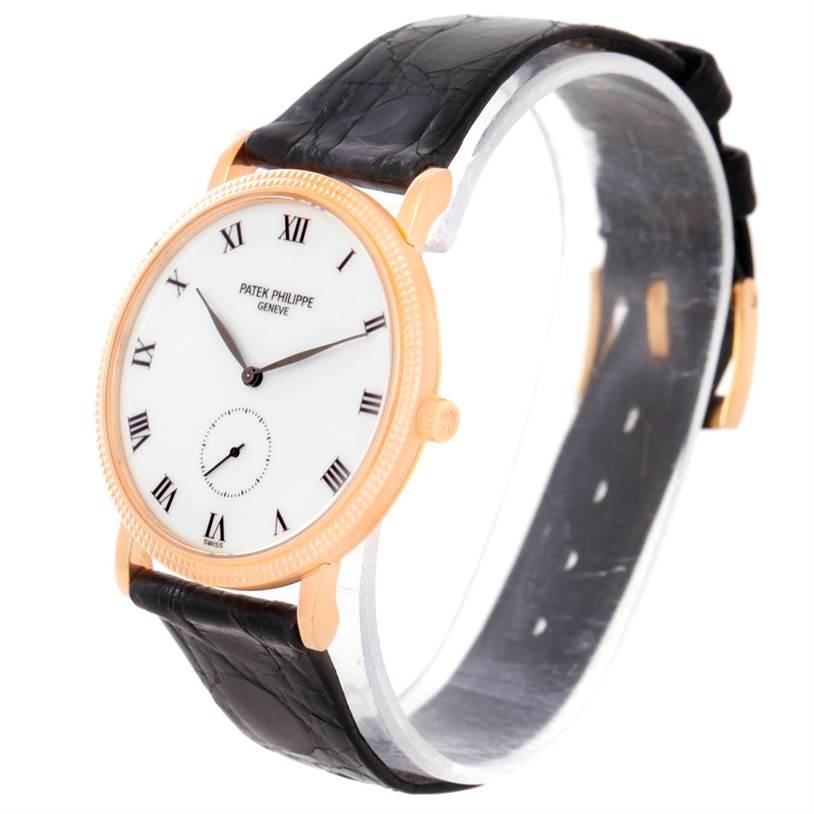 The Patek Philippe Calatrava 3919 Men
s Rose Gold White Dial 3919 Men
s Rose Gold White Dial watch is shown at an angle emphasizing the face, bezel, band, and crown.