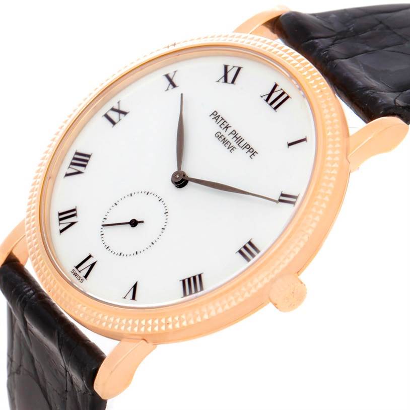 This image shows a Patek Philippe Calatrava 3919 Men
s Rose Gold White Dial 3919 Men
s Rose Gold White Dial watch from an angled view, highlighting its face, bezel, and leather strap.