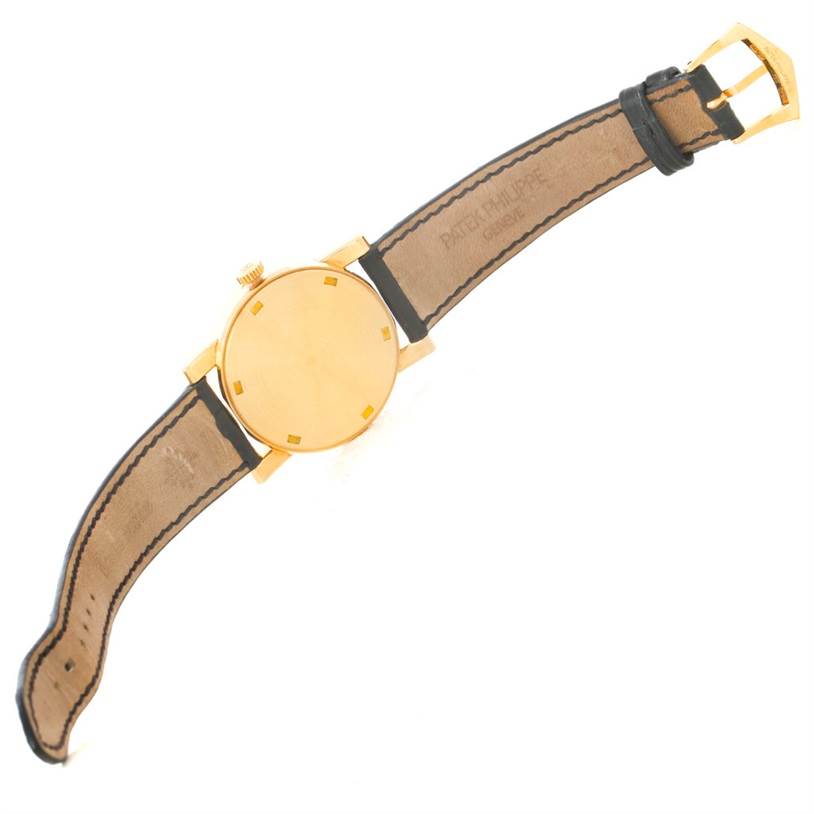 This image shows the back and strap of a Patek Philippe Calatrava 5012 Men
s Yellow Gold Beige Dial 5012 Men
s Yellow Gold Beige Dial watch at a slight angle.