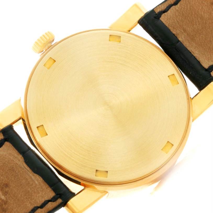 The image shows the back case and part of the strap of the Calatrava watch by Patek Philippe from a top-down angle.