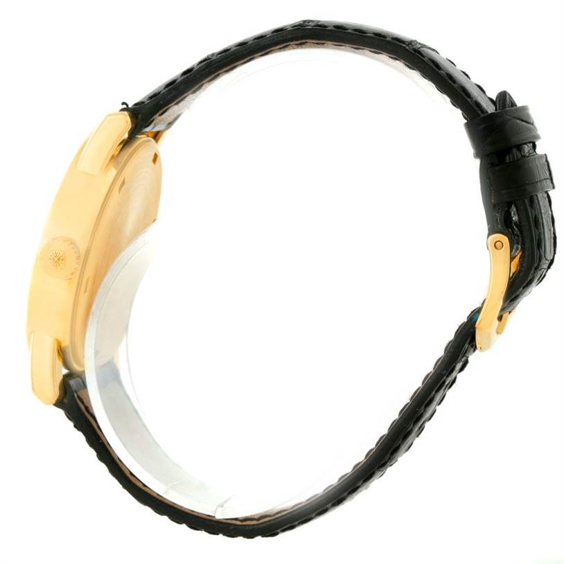 This side view of the Patek Philippe Calatrava 5012 Men
s Yellow Gold Beige Dial 5012 Men
s Yellow Gold Beige Dial watch shows the gold case and black leather strap with buckle.