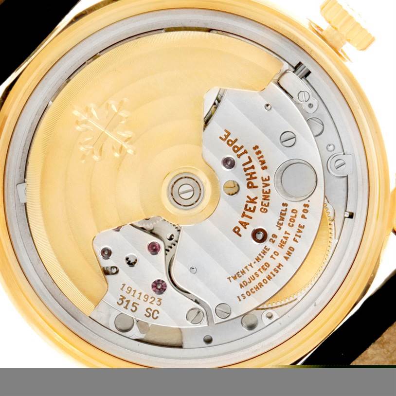 The image shows the back angle of the Patek Philippe Calatrava 5012 Men
s Yellow Gold Beige Dial 5012 Men
s Yellow Gold Beige Dial watch, highlighting its movement and internal mechanics.