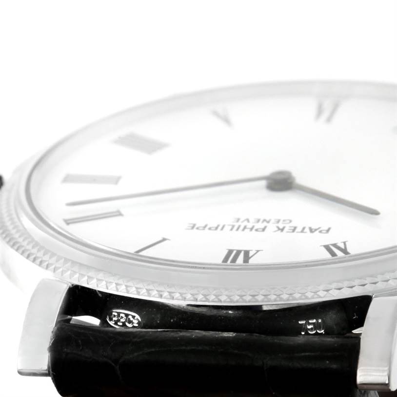 This image shows a close-up side view of the dial, bezel, and strap attachment of a Patek Philippe Calatrava 5120 Men's White Gold White Dial 5120 Men's White Gold White Dial watch.