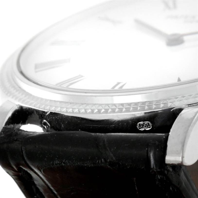 The image shows a close-up angled view of the bezel, dial, and leather strap of the Patek Philippe Calatrava 5120 Men's White Gold White Dial 5120 Men's White Gold White Dial watch.