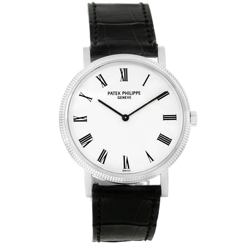 The image shows a front view of a Calatrava model by Patek Philippe, featuring a black leather strap and white dial with Roman numerals.