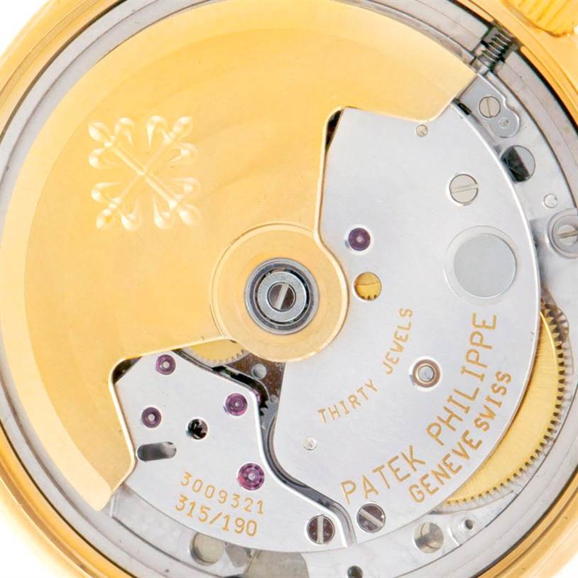 The image shows a close-up of the movement mechanism of a Patek Philippe Calatrava 3802 Men's Yellow Gold White Dial 3802 Men's Yellow Gold White Dial watch.