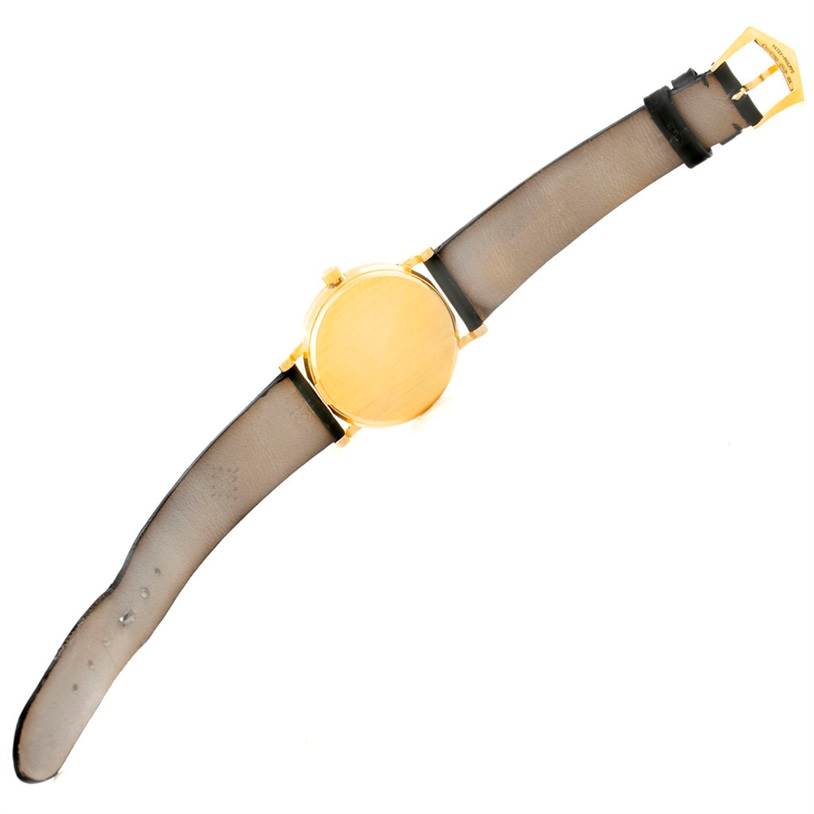 This image shows a Patek Philippe Calatrava 3802 Men's Yellow Gold White Dial 3802 Men's Yellow Gold White Dial watch from the back, highlighting its gold case and full leather strap.