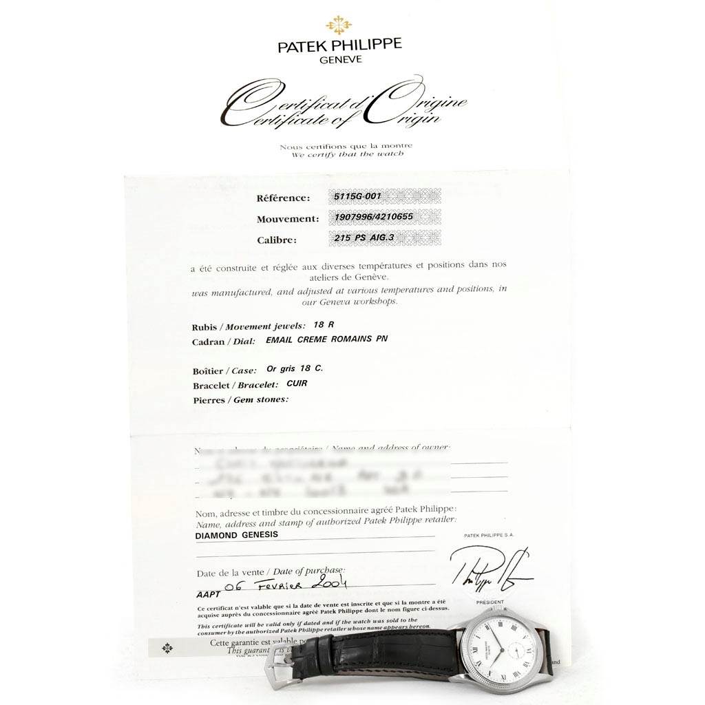 The image shows a Patek Philippe Calatrava 5115G Men
s White Gold White Dial 5115G Men
s White Gold White Dial watch placed on a Certificate of Origin, showcasing the watch
s face and leather strap.