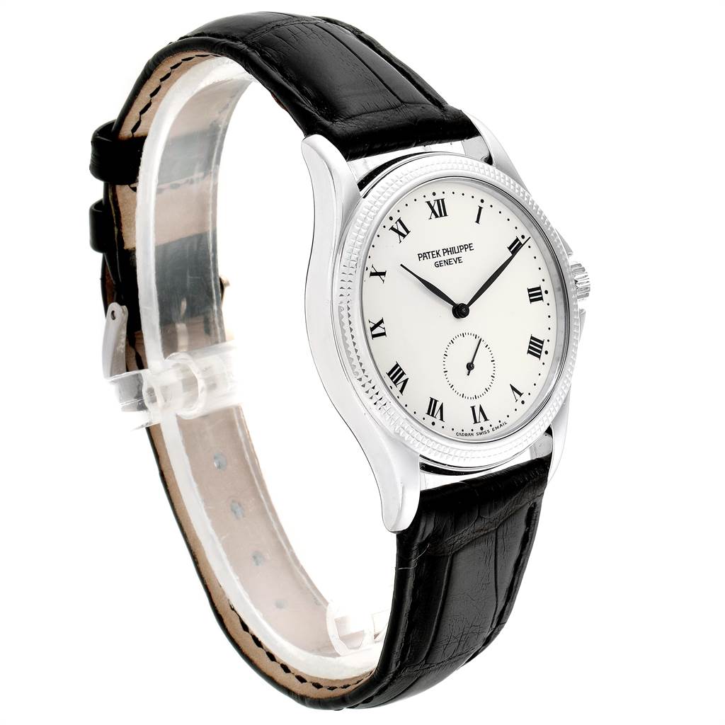 The image shows a side view of a Patek Philippe Calatrava 5115G Men
s White Gold White Dial 5115G Men
s White Gold White Dial watch, highlighting its black leather strap and white dial with Roman numerals.