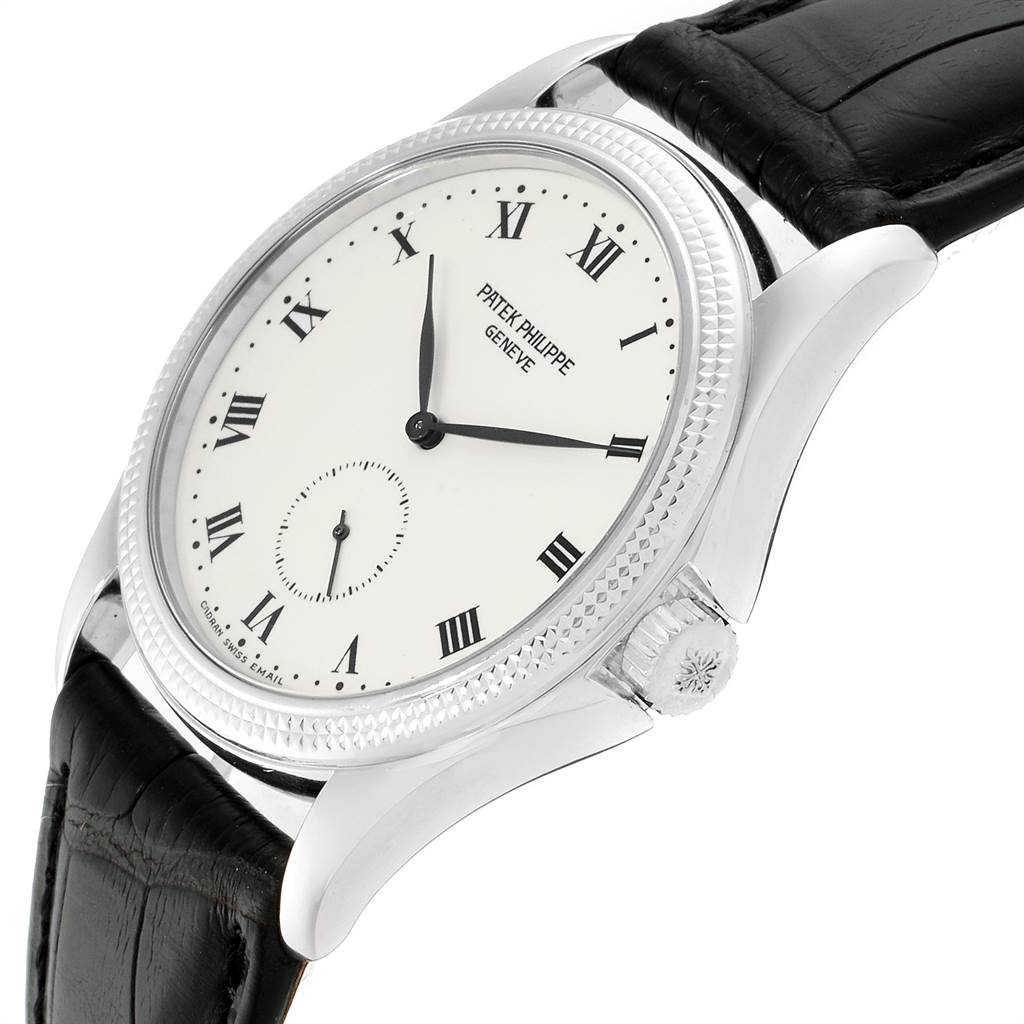 The image shows a Patek Philippe Calatrava 5115G Men
s White Gold White Dial 5115G Men
s White Gold White Dial watch at an angled side view, highlighting the face, crown, and leather strap.
