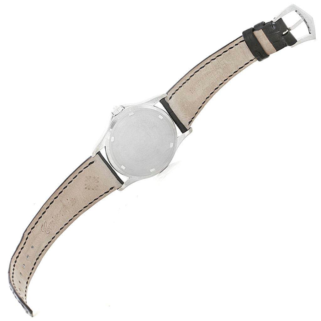 The image shows the back view of a Patek Philippe Calatrava 5115G Men
s White Gold White Dial 5115G Men
s White Gold White Dial watch, displaying its case back and leather strap.