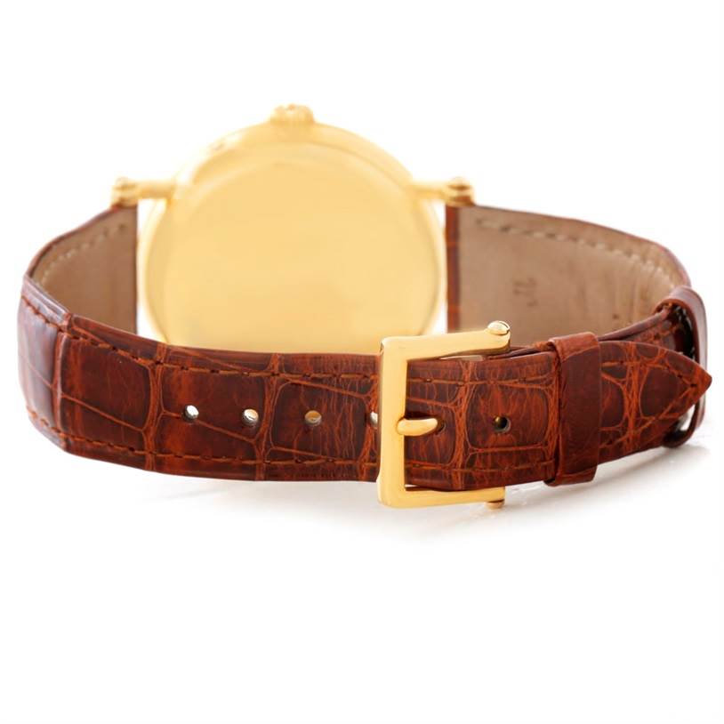 This image shows the back view of the Patek Philippe 5054 Men's Yellow Gold White Dial 5054 Men's Yellow Gold White Dial Power Reserve Moonphase Yellow Gold Watch 5054 with a brown leather strap and gold buckle.