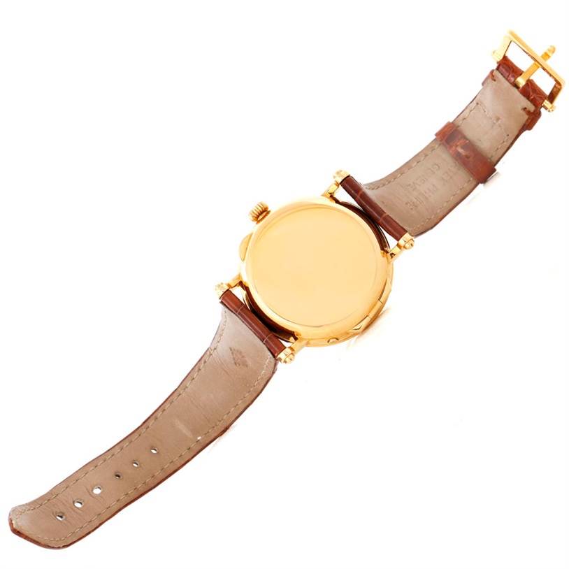 The image shows the back view of the Patek Philippe 5054 Men's Yellow Gold White Dial 5054 Men's Yellow Gold White Dial Power Reserve Moonphase Yellow Gold Watch 5054 with its brown leather strap opened.