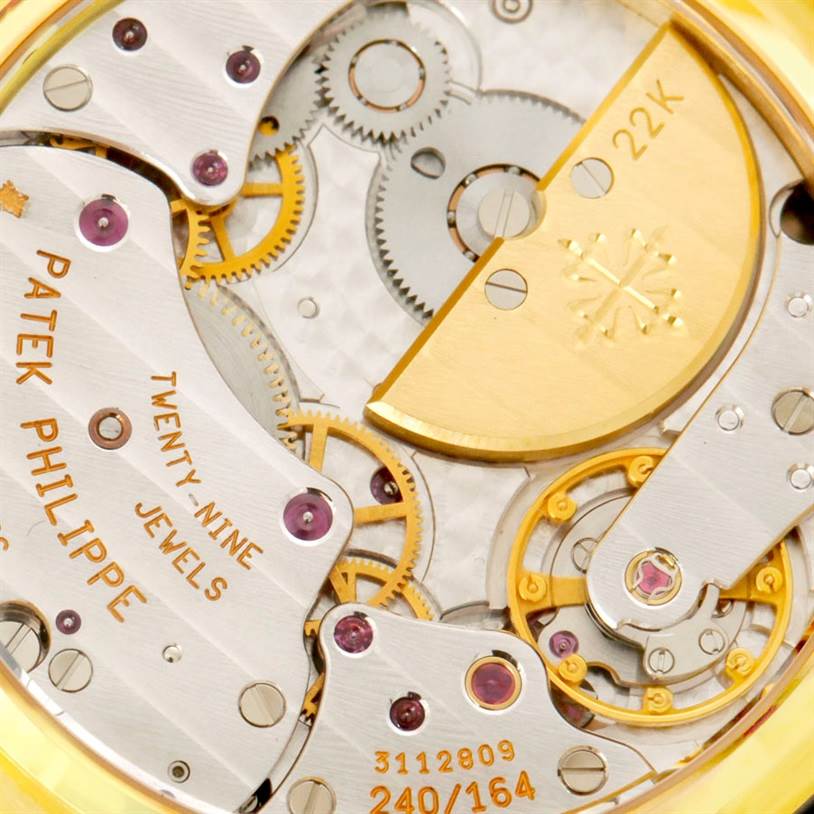 This close-up image showcases the intricate gears and mechanisms of the Patek Philippe 5054 Men's Yellow Gold White Dial 5054 Men's Yellow Gold White Dial Power Reserve Moonphase Yellow Gold Watch 5054.